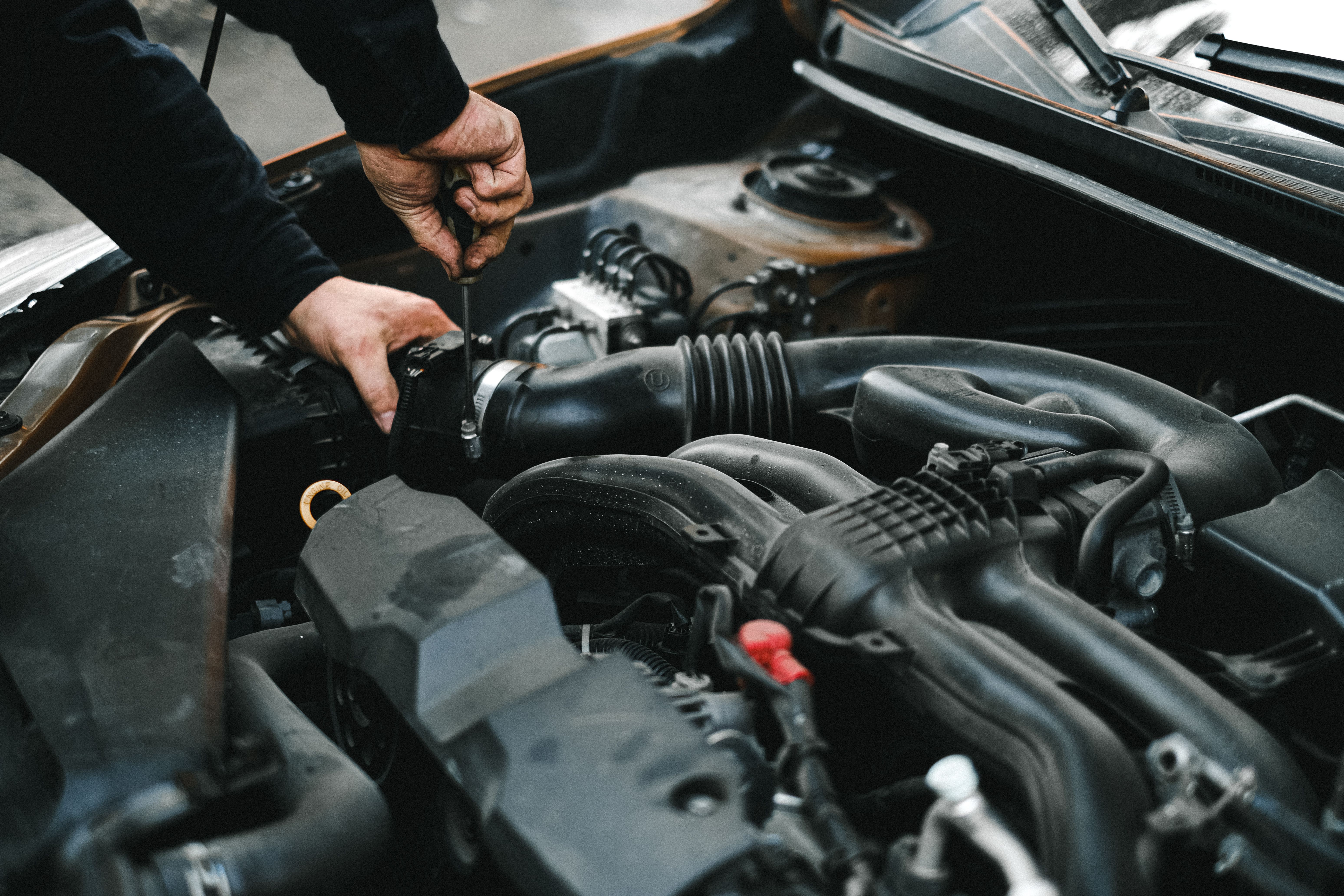 Professional mechanic working on vehicle